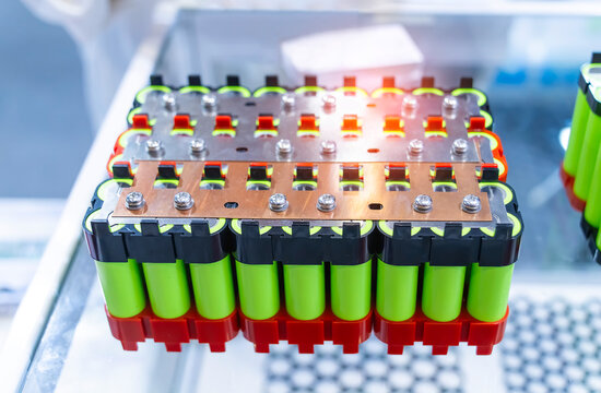 Metal parts with shiny steel cylindrical surface closeup. disassembled lithium ion form factor cell battery pack
