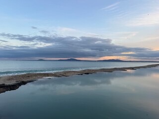 Fototapeta premium Peaceful Coastal Sunrise with Reflections