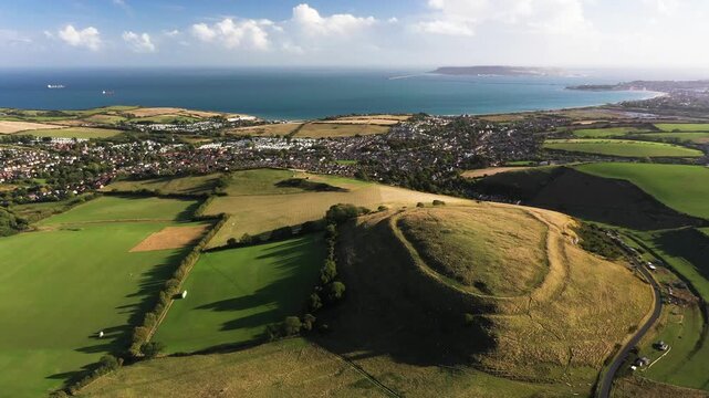 Chalbury early Iron Age hillfort. View south toward Weymouth Bay, English Channel. Video rotate clockwise. Single rampart strategic site. Enclosed depressions are hut platforms and storage pits