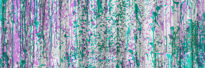 A close-up of a corrugated metal sheet covered in turquoise paint drips and splatters on a weathered white background.