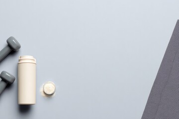 Minimalist arrangement featuring supplements, dumbbells, and fit