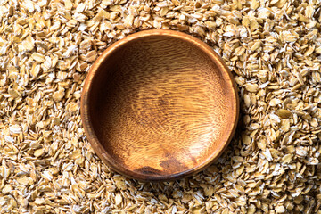 Empty bamboo bowl with oatmeal. Healthy food for diet.