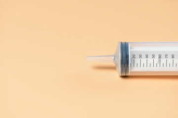 Empty syringe on yellow background. Universal medical content.