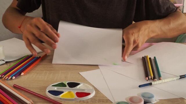 a guy draws with pencils