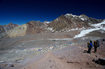 A tent camp set up on the slopes of snowy mountains in winter for climbers, tourists, mountaineers, and scientists