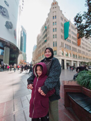 Hijab mother and little girl wearing hoodie during winter in China.