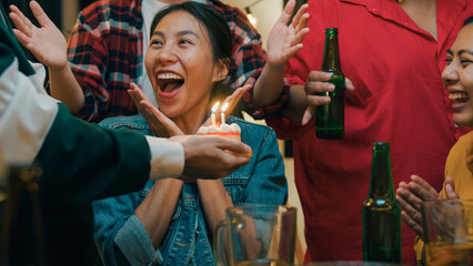 Group of young adult Asia friend surprised with birthday cake and drinking alcohol beer and fun...