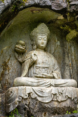 the stone statue avalokitesvara made in Yuan Dynasty from Peak Flown From Afar Fei Lai Fen, Ling Jiu Feng , stands next to Lingyin Temple Hangzhou China