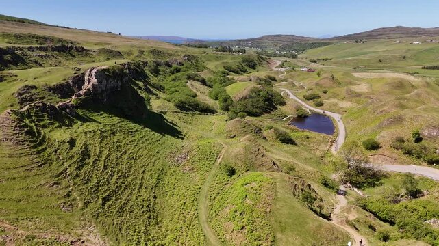 Drone shot of Castle Ewen and pond in Fairy Glen, Isle of Skye, Scotland, UK