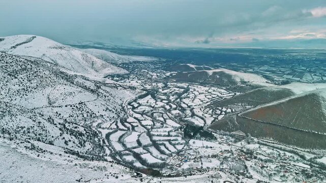 Aerial drone footage of the snow-covered village
