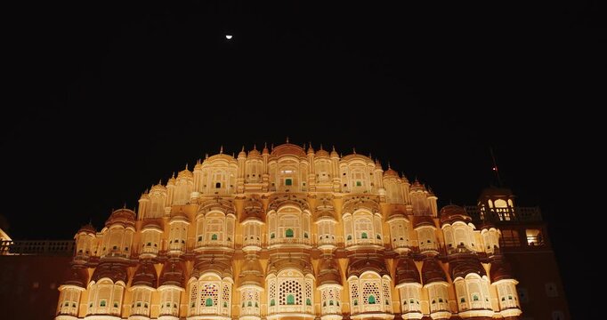 Hawa Mahal Palace In Night Illuminations. Dark Night Sky Above Palace Of Winds. Built From Red And Pink Sandstone. Very Unique As It Has Many Small Windows And Balconies That Seem Like Honeycomb
