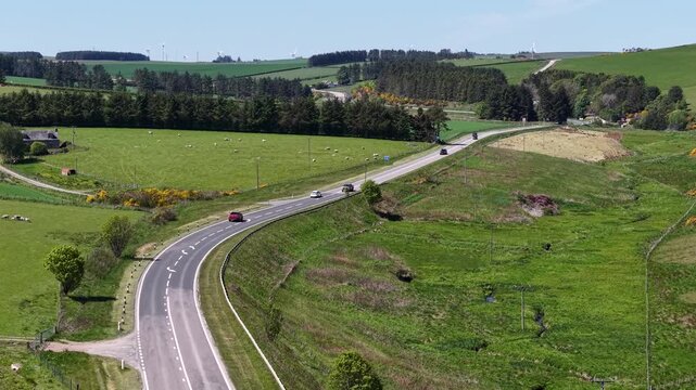 Aerial view of winding road through Scottish farmland, Scotland, United Kingdom
