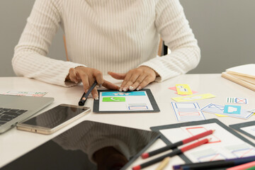 Creative web designer planning UI application and developing digital template