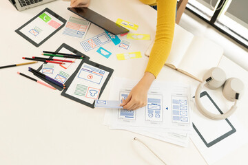 Creative web designer planning UI application and developing digital template