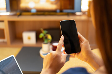 Woman enjoys book and music in modern abode.