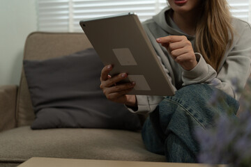 Cheerful woman use smartphone, enjoy personal chat exchanges messages through mobile application, learn new AI platform for business or fun, distracted from workflow on laptop in workplace.