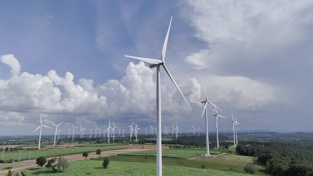 Wind turbines at green mountain hill clean sustainable electricity power, Green generator cloud blue sky fly over with drone shot