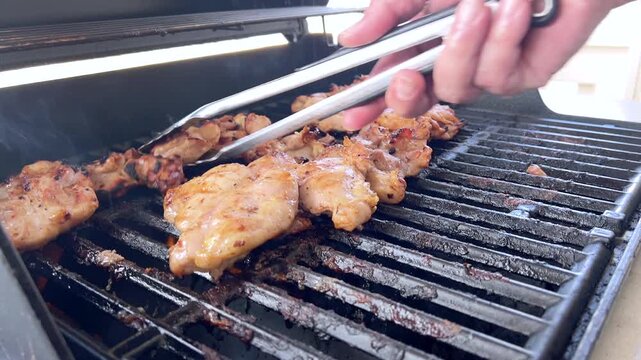 Juicy Chicken Thighs Being Grilled to Perfection on a Small Weber Grill