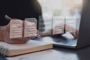 Person working on laptop and writing in notebook, with digital document icons overlayed, representing online task management and data processing and the integration of physical and digital workflows.