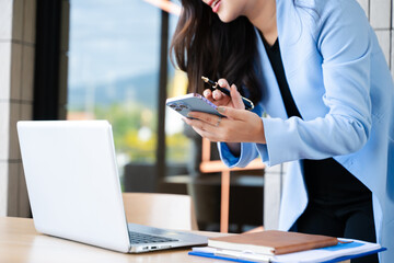 Businesswoman hand working digital marketing media in virtual screen with mobile phone and modern compute with VR icon diagram at office