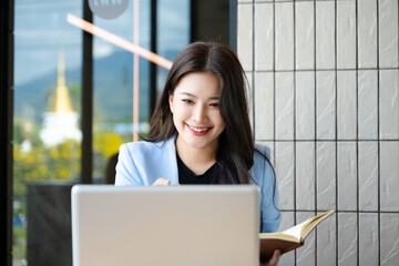 Business woman using tablet and laptop for doing math finance on an office desk, tax, report, accounting, statistics, and analytical research concept