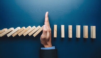 Risk Management Concept with Hand Stopping Domino Effect for Business Protection