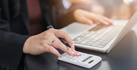 close up accountant businesswoman accountant hand use calculator to calculate about profit and budget on project for business and financial concept