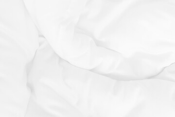 Close up top view of white bedding sheet and wrinkle messy blanket in bedroom after wake up in the morning.