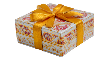 A festive red Christmas gift box with a gold ribbon bow is isolated on white paper as a holiday surprise package for a New Year celebration or birthday anniversary wrapping decoration