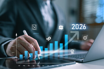 Businessman analyzing digital growth chart using AI technology, planning data-driven strategy for business success in 2026 with futuristic interface and innovation tools.