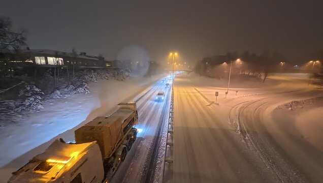 Snowstorm in Stockholm Sweden. Authorities advise everyone to stay home. Snowplows have difficulty keeping the roads clear. Photo of cars at road 226 in Huddinge.