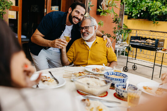 Latin father and son enjoying quality time during a barbecue event