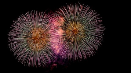 Fototapeta premium Colorful fireworks light up dark night sky, bringing joyful and festive atmosphere for people celebrating new year's eve with excitement and cheer.