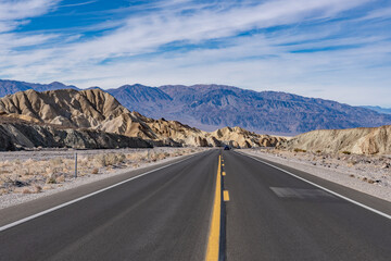 Death Valley National Park, Inyo County. California State Route 190. near Twenty Mule Team Road entrance. (Tf）Playa and playa margin rocks of Furnace Creek basin. In the distance is the Panamint Range