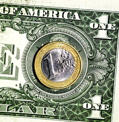 Euro coin placed on a US dollar bill. Concept of currency exchange, global economy, finance, and international money.