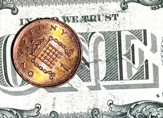 One cent copper coin on US dollar bill. Financial background representing savings, investment, economy and money value.