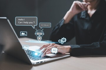 Businesswoman using laptop with AI chatbot interface virtual assistant icons, representing artificial intelligence, automation and digital customer support technology.