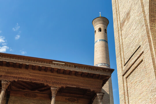 Hazrati Imam Mosque minaret and traditional wooden iwan detail in Tashkent, Uzbekistan under clear blue sky