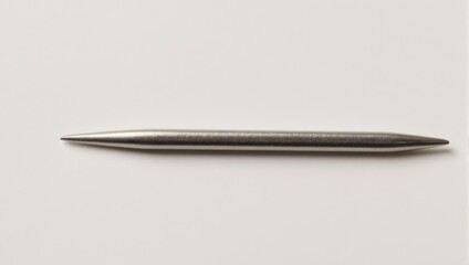 Sleek Metal Knitting Needle on White Background.