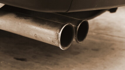 Car Exhaust Pipes Closeup Side View Sepia. Automotive Metal Detail