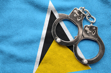 Flag of Saint Lucia and police handcuffs. Crime and offenses in country Concept
