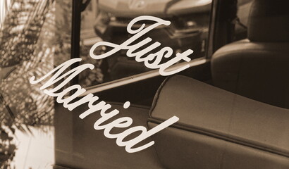 Wedding Car Window Lettering Closeup. Romantic Celebration Detail Sepia Tone