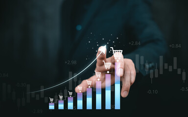 E-commerce sales growth concept with shopping cart icons and rising bar chart, businessman touching digital interface, online retail, revenue increase, marketing analytics, and business success.