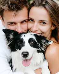 Joyful couple embracing their happy dog in a lush outdoor setting