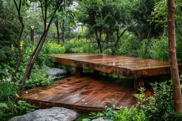 Fototapeta premium Wet wooden bridge in peaceful garden setting, surrounded by lush greenery and rocks, creating a tranquil atmosphere after the rain