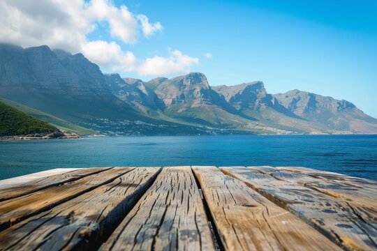 Empty wooden pier with breathtaking view of the ocean and mountains in hout bay, a suburb of cape town, south africa - Powered by Adobe