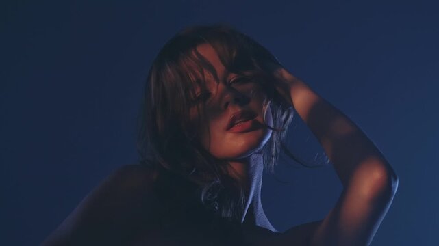 A captivating portrait of a woman cast in dramatic low light, creating a mysterious and alluring atmosphere.