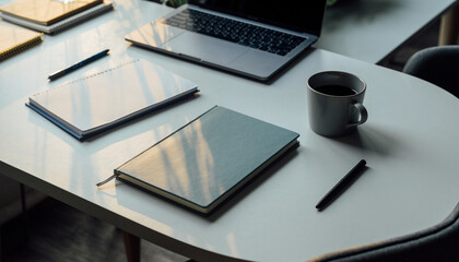 Modern workspace with laptop, notebooks, and coffee on sleek desk