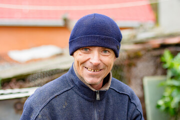 Authentic portrait of a smiling man in a blue beanie and fleece jacket, radiating genuine happiness. Captures the spirit of everyday life and real people. © dizfoto1973