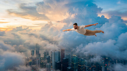 Man flying alone above city clouds at dusk